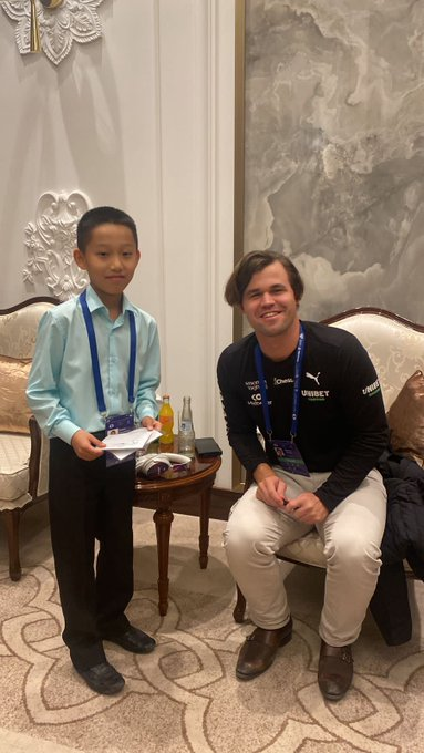 Roman Shogdzhiev pictured with Magnus Carlsen - the world's strongest chess player.