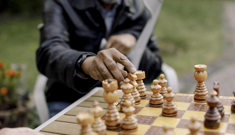 A senior man playing chess in park.
© Photo: Getty Images/Maskot